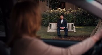 Movie still from “It's Complicated” (2009), directed by Nancy Meyers – A man sitting on top of a white swing; Wide shot, Over the shoulder angle