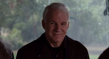 Movie still from “It's Complicated” (2009), directed by Nancy Meyers – An older man with white hair wearing a black shirt; Close Up shot, Over the shoulder angle