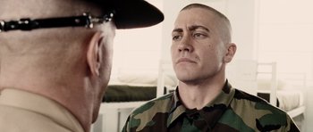 Movie still from “Jarhead” (2005), directed by Sam Mendes – A man in a military uniform talking to another man; Close Up shot, Over the shoulder angle