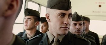 Movie still from “Jarhead” (2005), directed by Sam Mendes – A group of men in military fatigues standing next to each other; Close Up shot, Low angle