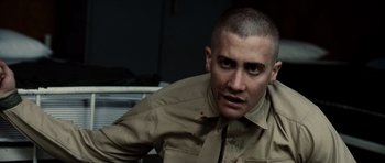 Movie still from “Jarhead” (2005), directed by Sam Mendes – A person wearing a shirt; Close Up shot, Over the shoulder angle