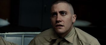 Movie still from “Jarhead” (2005), directed by Sam Mendes – A person wearing a shirt and tie; Close Up shot, Over the shoulder angle