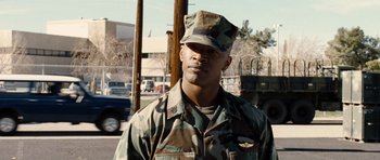 Movie still from “Jarhead” (2005), directed by Sam Mendes – A man in a military uniform standing on the side of the road; Close Up shot, Low angle