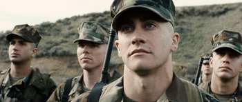 Movie still from “Jarhead” (2005), directed by Sam Mendes – Two men in military uniforms are standing next to each other; Close Up shot, Low angle