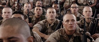 Movie still from “Jarhead” (2005), directed by Sam Mendes – A group of men in camouflage uniforms with guns; Medium shot, Over the shoulder angle