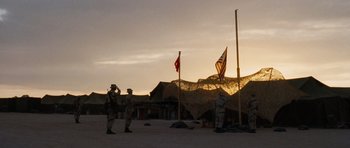Movie still from “Jarhead” (2005), directed by Sam Mendes – A group of men standing next to each other in front of an american flag; Extreme Wide shot, Low angle