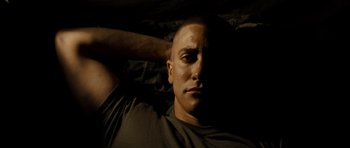 Movie still from “Jarhead” (2005), directed by Sam Mendes – A person laying on a bed; Close Up shot, Low angle