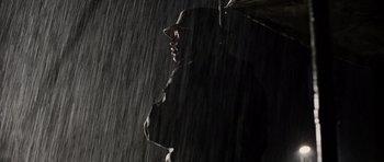 Movie still from “Jarhead” (2005), directed by Sam Mendes – A person holding an umbrella in the rain; Medium shot, Low angle