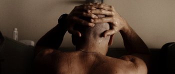 Movie still from “Jarhead” (2005), directed by Sam Mendes – A man with his hands on his head; Close Up shot, Low angle