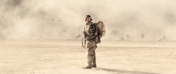Movie still from “Jarhead” (2005), directed by Sam Mendes – A man standing in the middle of the desert; Wide shot, Low angle