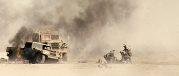 Movie still from “Jarhead” (2005), directed by Sam Mendes – A group of soldiers in the desert with a truck; Extreme Wide shot, Low angle