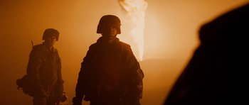 Movie still from “Jarhead” (2005), directed by Sam Mendes – A person wearing a helmet and a gas mask; Medium shot, Low angle