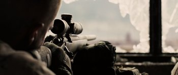 Movie still from “Jarhead” (2005), directed by Sam Mendes – A man with a rifle and a backpack; Extreme Close Up shot, Over the shoulder angle