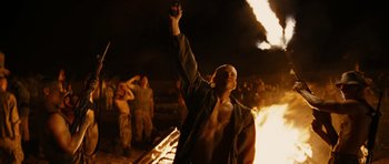 Movie still from “Jarhead” (2005), directed by Sam Mendes – A man holding his hand up in the air; Medium shot, Low angle