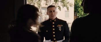Movie still from “Jarhead” (2005), directed by Sam Mendes – A man in a military uniform standing next to a woman; Medium shot, Over the shoulder angle