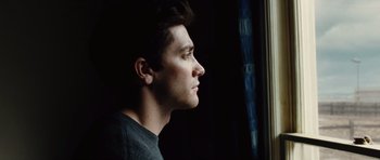 Movie still from “Jarhead” (2005), directed by Sam Mendes – A man looking out of a window at night; Close Up shot, Low angle