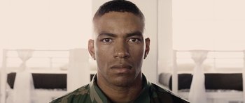 Movie still from “Jarhead” (2005), directed by Sam Mendes – A person wearing a military uniform; Close Up shot, Low angle
