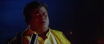 Movie still from “Jeans” (1998), directed by S. Shankar – A man in a yellow shirt and a microphone; Close Up shot, Low angle