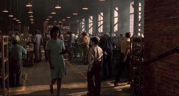 Movie still from “Jumanji” (1995), directed by Joe Johnston – A group of people standing in a room with machines; Wide shot, High angle