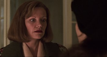 Movie still from “Jumanji” (1995), directed by Joe Johnston – A woman looking at her reflection in a mirror; Close Up shot, Over the shoulder angle