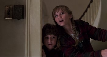 Movie still from “Jumanji” (1995), directed by Joe Johnston – Two young children are looking up at the camera; Close Up shot, Low angle