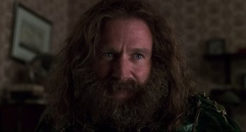 Movie still from “Jumanji” (1995), directed by Joe Johnston – A person with long hair and a beard; Close Up shot, Over the shoulder angle