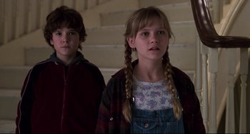 Movie still from “Jumanji” (1995), directed by Joe Johnston – Two young children standing next to each other; Close Up shot, Low angle