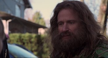 Movie still from “Jumanji” (1995), directed by Joe Johnston – A man with long hair and a long beard; Close Up shot, Over the shoulder angle
