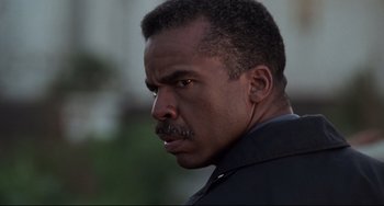 Movie still from “Jumanji” (1995), directed by Joe Johnston – A person wearing a black shirt; Close Up shot, Low angle