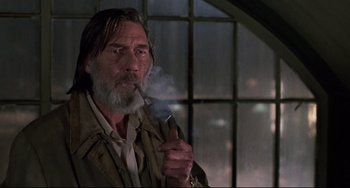 Movie still from “Jumanji” (1995), directed by Joe Johnston – An older man smoking a pipe in front of a window; Close Up shot, Low angle