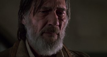 Movie still from “Jumanji” (1995), directed by Joe Johnston – An old man with a beard and a white mustache; Close Up shot, Low angle