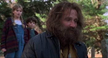 Movie still from “Jumanji” (1995), directed by Joe Johnston – A person with a beard; Medium shot, Over the shoulder angle