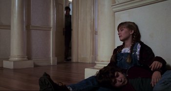 Movie still from “Jumanji” (1995), directed by Joe Johnston – Two young girls sitting on the ground in a room; Medium shot, Low angle