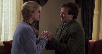 Movie still from “Jumanji” (1995), directed by Joe Johnston – A man and a woman holding hands in a room; Medium shot, Over the shoulder angle