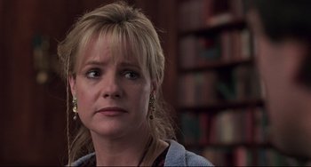 Movie still from “Jumanji” (1995), directed by Joe Johnston – A person with a book shelf in the background; Close Up shot, Over the shoulder angle