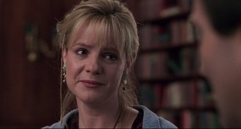 Movie still from “Jumanji” (1995), directed by Joe Johnston – A person with a book shelf in the background; Close Up shot, Over the shoulder angle