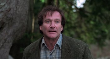 Movie still from “Jumanji” (1995), directed by Joe Johnston – A person wearing a jacket; Close Up shot, Over the shoulder angle