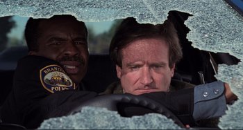 Movie still from “Jumanji” (1995), directed by Joe Johnston – Two men in the back seat of a car; Close Up shot, Low angle