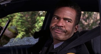 Movie still from “Jumanji” (1995), directed by Joe Johnston – A person sitting in a car; Close Up shot, Low angle