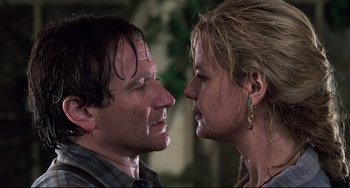 Movie still from “Jumanji” (1995), directed by Joe Johnston – A man and a woman face to face in the rain; Close Up shot, Low angle
