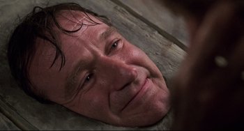 Movie still from “Jumanji” (1995), directed by Joe Johnston – A person laying on the ground; Close Up shot, Overhead angle