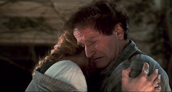 Movie still from “Jumanji” (1995), directed by Joe Johnston – A man and a woman embracing each other; Close Up shot, Over the shoulder angle