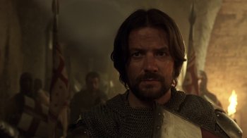 Movie still from “Knightfall” (2017), created by Richard Rayner – A person wearing a chain mail armor; Close Up shot, Over the shoulder angle