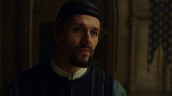 Movie still from “Knightfall” (2017), created by Richard Rayner – A person with a beard; Close Up shot, Over the shoulder angle