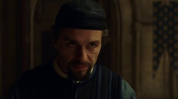 Movie still from “Knightfall” (2017), created by Richard Rayner – A person wearing a hat; Close Up shot, Over the shoulder angle