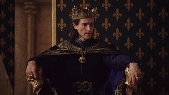 Movie still from “Knightfall” (2017), created by Richard Rayner – A man wearing a crown sitting in a chair; Medium shot, Low angle