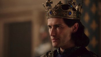 Movie still from “Knightfall” (2017), created by Richard Rayner – A person wearing a crown; Close Up shot, Low angle