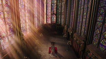 Movie still from “Knightfall” (2017), created by Richard Rayner – A woman sitting in front of stained glass windows in a church; Extreme Wide shot, High angle