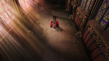 Movie still from “Knightfall” (2017), created by Richard Rayner – A woman sitting in the middle of an aisle in a church; Extreme Wide shot, High angle