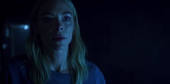 Movie still from “Black Summer” (2019), created by John Hyams – A woman with long blonde hair is in the dark; Close Up shot, Low angle